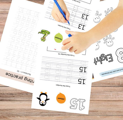 Child's hand tracing numbers on educational worksheets with a pen.