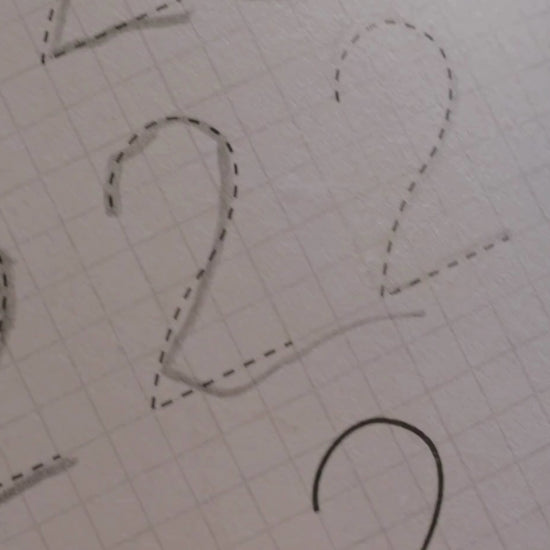 A little girl is tracing numbers