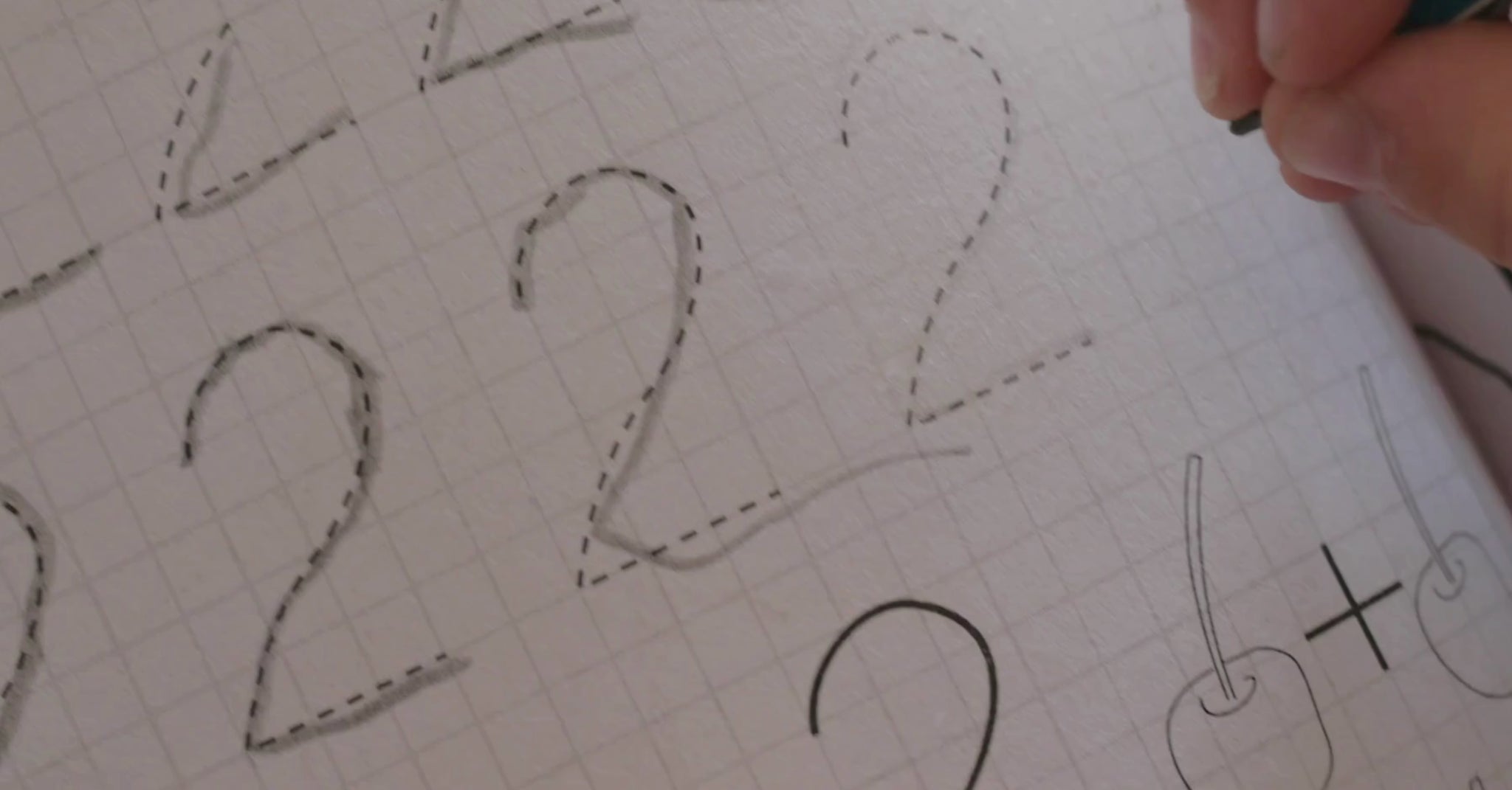 A little girl is tracing numbers