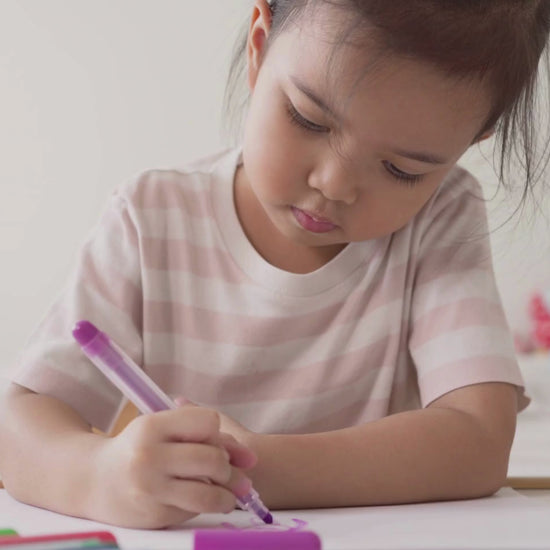 A little girl is coloring a princess