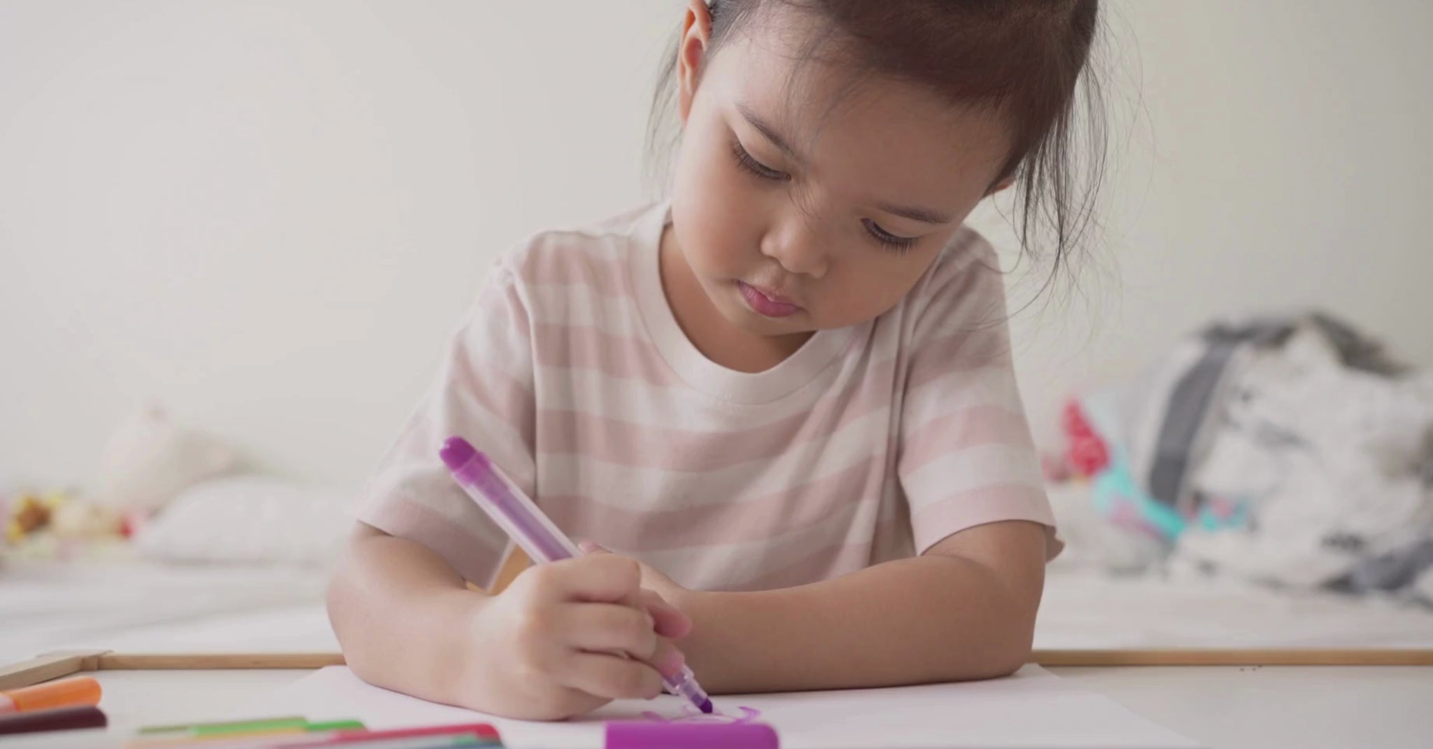 A little girl is coloring a princess