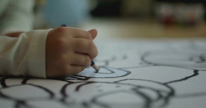 A child is coloring  animals on coloring Book of KidzzyLab brand