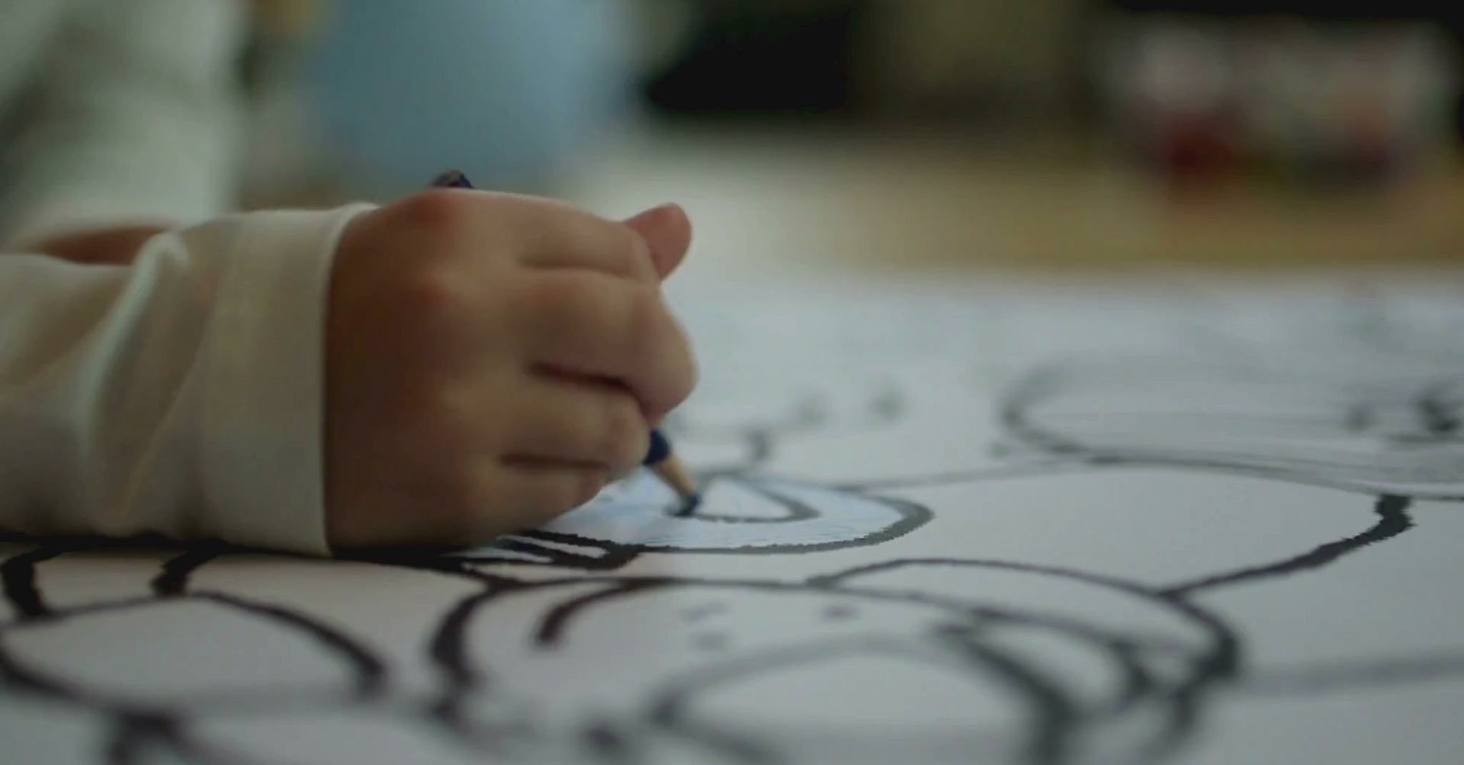 A child is coloring  animals on coloring Book of KidzzyLab brand