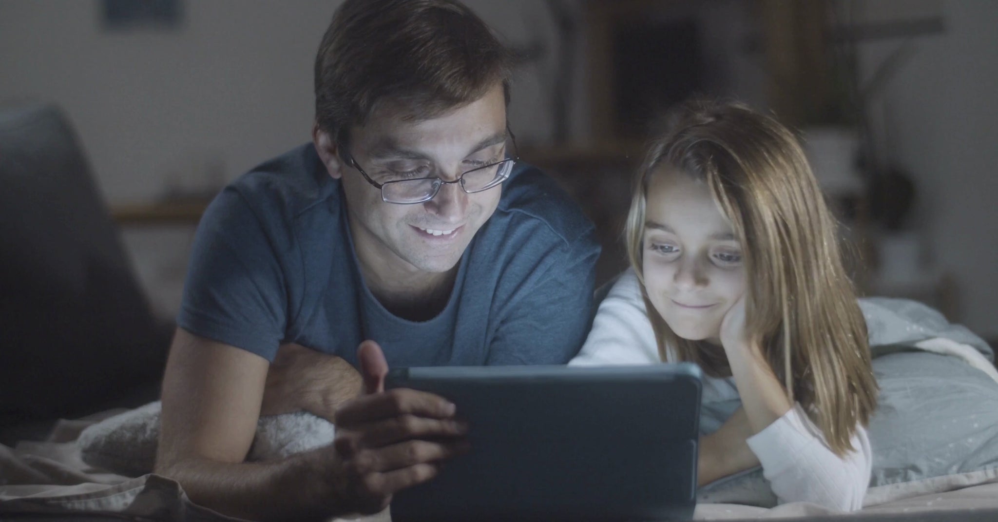 A father and his daughter are reading the story Lina and Toto's Adventure by KidzzyLab.
