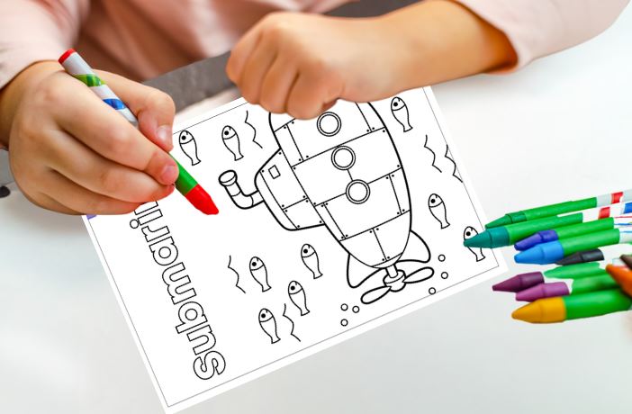 Coloring sheet with a robot design and markers on a table